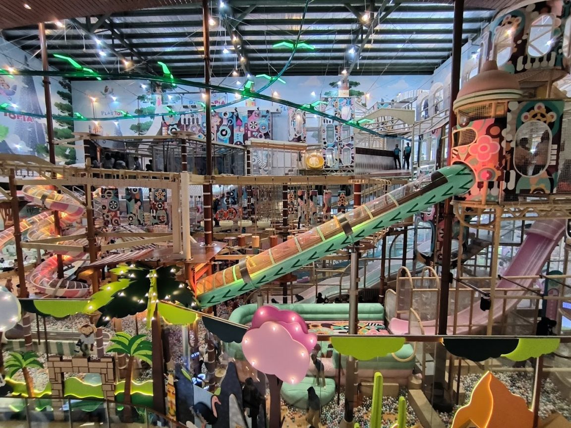 Indoor playground with slides and climbing structures